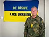 Eystein Kvarving i militæruniform foran et Ukraina-flagg med teksten «Be brave like Ukraine».