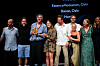 En gruppe mennesker står på scenen med pris og diplom under en feiring i Cannes.