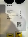 Prisliste ved Per Højs stand på Tigerbrøl, med QR-kode og gule produkter nederst i bildet.